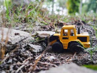 tractor  toy on the ground in the garden