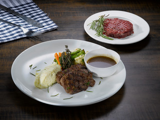 grilled beef steak with sauce and vegetables