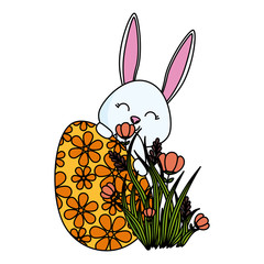 cute rabbit with easter egg painted in the garden