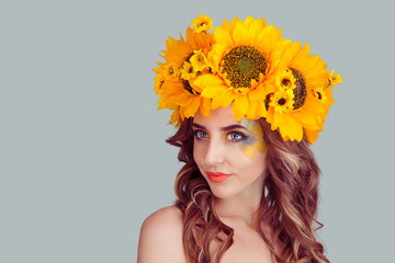 closeup portrait, confident, successful, beautiful attractive young woman in floral crown from sunflowers, posing looking away to side smiling fashion girl, isolated on grey gray background wall.