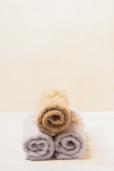Clean soft towels tied with a natural rope and folded slide on a light background. Selective focus. Vertical frame.