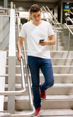 Fototapeta na wymiar Man with phone on stairs of subway