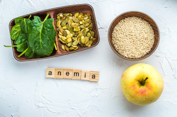 Spinach, pumpkin seeds, sesame, apple on a white background. Trace element FE. Close-up.