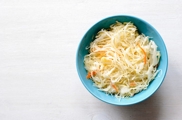Blue bowl of fermented cabbage from above