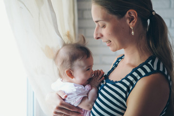 baby in the arms of the mother. Woman holding a child