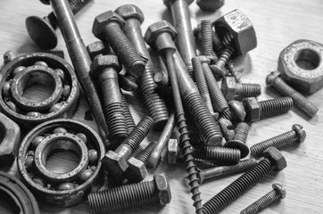 old nails and bolts are scattered on the table