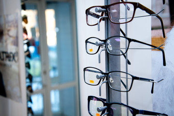 Showcase with glasses. Samples of multi-colored frames for glasses.