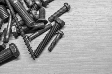 old nails and bolts are scattered on the table