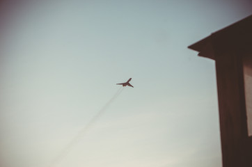 the plane flies in the sky, the plane against the sky