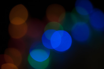 Blurred background, bright colored light bulbs, lights, the light from the garland.