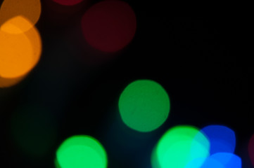 Blurred background, bright colored light bulbs, lights, the light from the garland.
