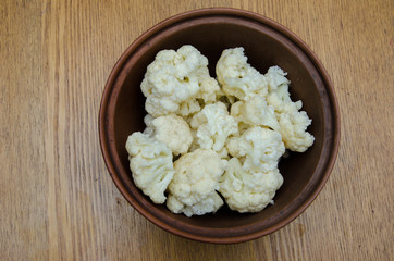 the cauliflower is in the plate, the cabbage is cut into pieces in the dish
