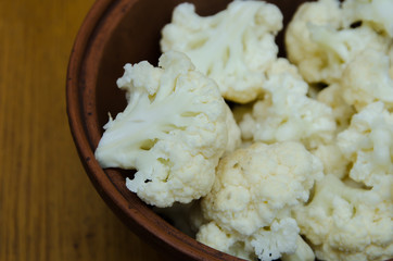 the cauliflower is in the plate, the cabbage is cut into pieces in the dish