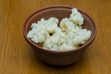 the cauliflower is in the plate, the cabbage is cut into pieces in the dish