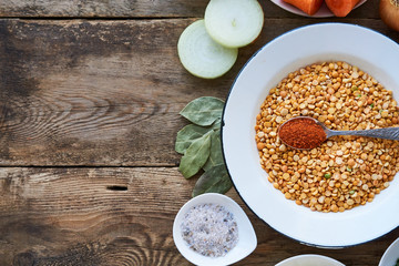 Ingredients for cooking pea porridge on a wooden background 