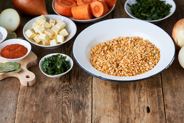 Ingredients for cooking pea porridge on a wooden background 