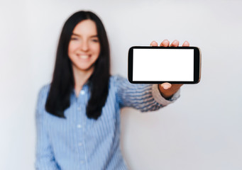 Beautiful girl show her smart phone. Empty black screen. Isolate.