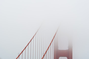 Golden Gate bridge covered in fog close up