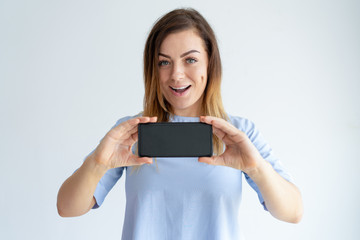 Cheerful woman showing smartphone screen