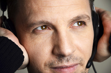 man listening to music on headphones