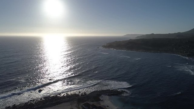 Aerial Footage. Totoralillo beach at Coquimbo region in north Chile at Atacama Desert an amazing wild beach with a nice peninsula, cottages, surf and awe cloudy colorful sunsets. Atacama Desert 1/6