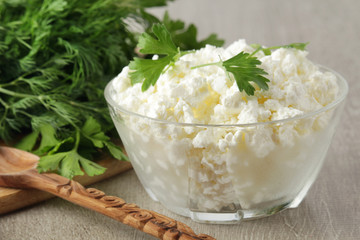 A bowl with cottage cheese and a bunch of green