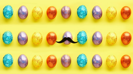 pattern with easter eggs on a yellow background. and one egg with a mustache. concept is like that all.