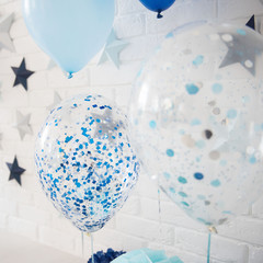 Balloons. Children party background. Holiday spirit. Circles and stars. Photo zone with paper stars, balloons, paper honeycombs, paper balls, pom poms, confetti.