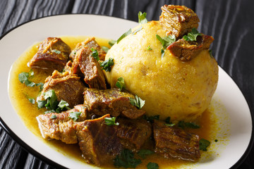 Puerto Rican Mofongo made from plantains, garlic and chicharron served with meat and broth...