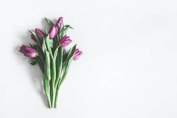 Flowers composition. Purple tulip flowers on pastel gray background. Valentines day, mothers day, womens day, spring, easter concept. Flat lay, top view, copy space