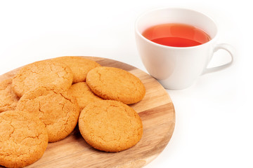 A photo of ginger cookies with a cup of tea on a white background with copy space