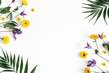 Fototapeta na wymiar Flowers composition. Yellow and purple flowers on white background. Spring, easter concept. Flat lay, top view, copy space