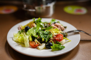 tuna salad with fresh vegetables in the white plate