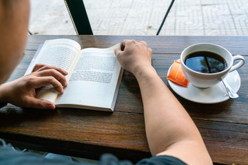 Young man read a book in the coffee shop