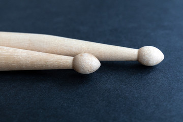 Two wooden drumsticks isolated on black background