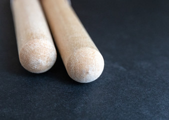 Two wooden drumsticks isolated on black background