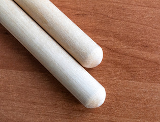 Two wooden drumsticks isolated on black background