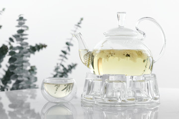 Hot flower tea in glass pot