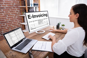 Businesswoman Preparing E-invoicing Bill On Computer