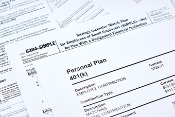 Tax reporting and retirement plan. Personal plan 401k form on against background 5304-simple tax form and other forms