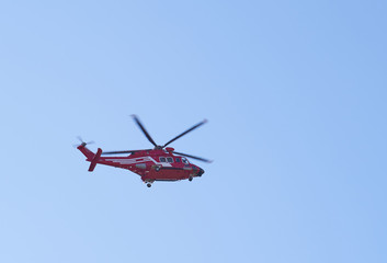 Fototapeta na wymiar Red helicopter on blue sky