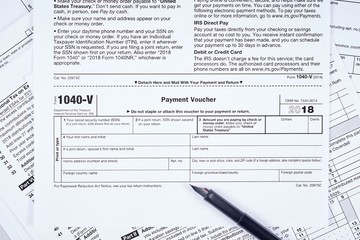 Tax payment form. 1040-v tax form, pen on background other forms