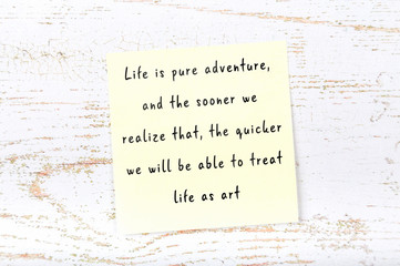 Positive inspiring quote handwritten on sticky note on wooden background