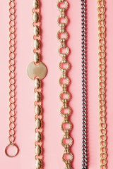 Golden chain on pink pastel. Luxury pattern.