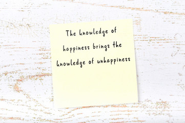 Positive inspiring quote handwritten on sticky note on wooden background