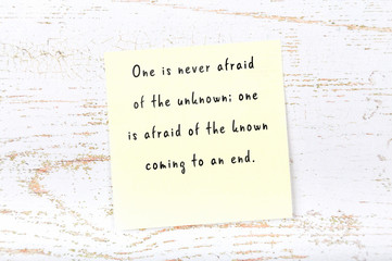 Positive inspiring quote handwritten on sticky note on wooden background