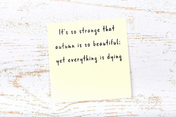 Positive inspiring quote handwritten on sticky note on wooden background