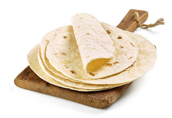 empty tortillas on wooden cutting board