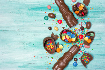 Chocolate traditional easter eggs and bunnies with bright colorful dragee and sugar sprinkles