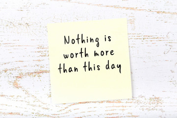 Positive inspiring quote handwritten on sticky note on wooden background